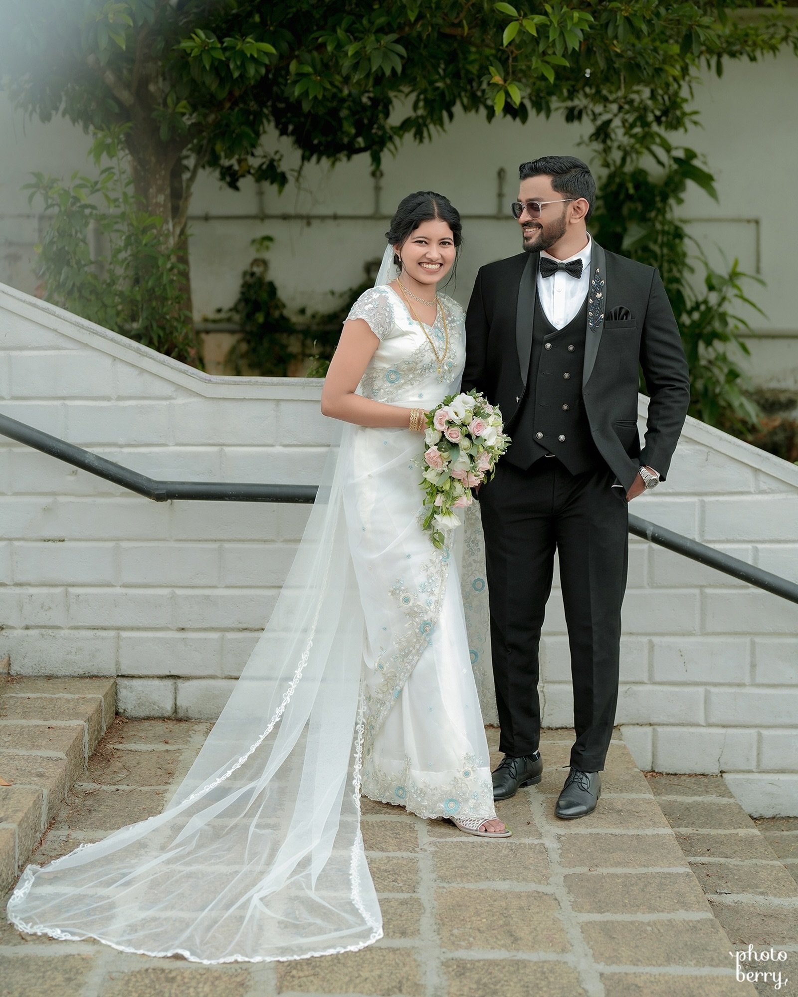 A bride in a copper saree standing for an elegant indoor portrait