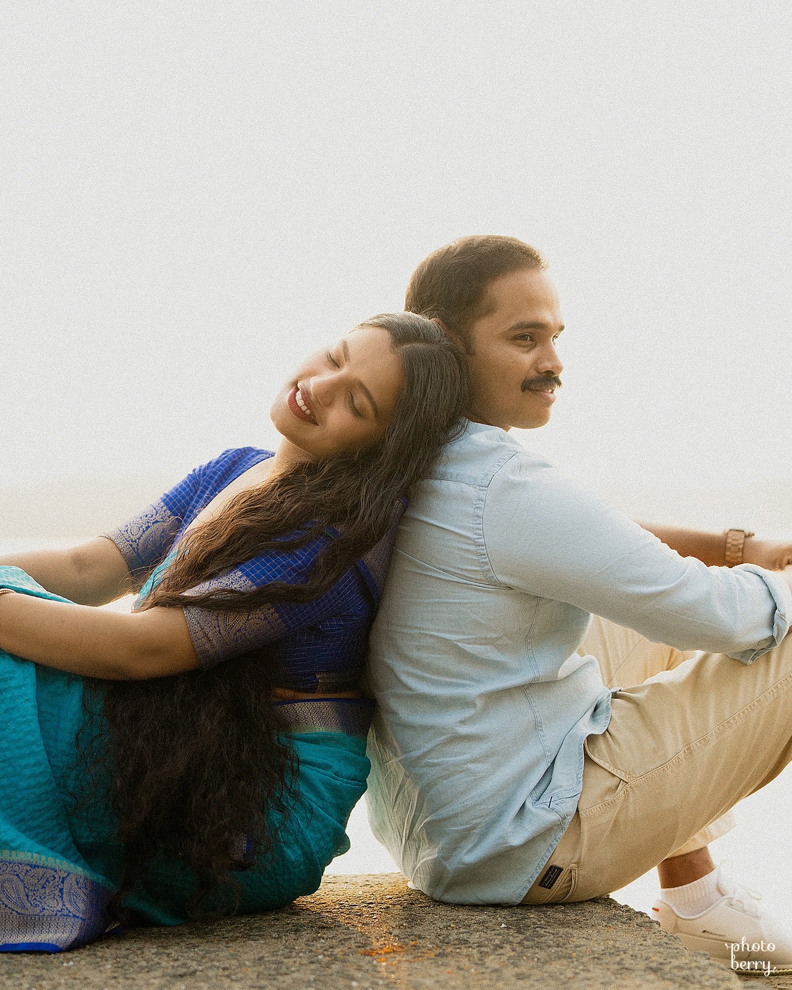 A couple leaning against one another in soft natural light